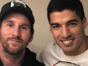 Messi and Suarez smiling for a photo